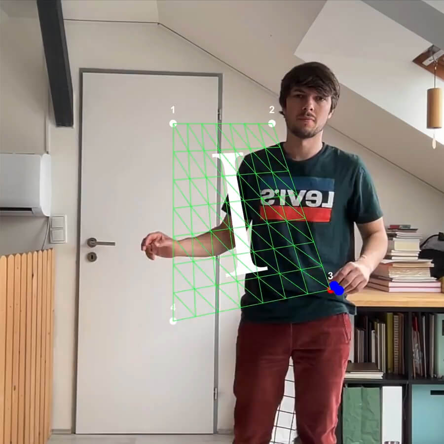 A webcam tracks my body. My hands are moving endpoints of a graphic canvas that transforms the letter I.