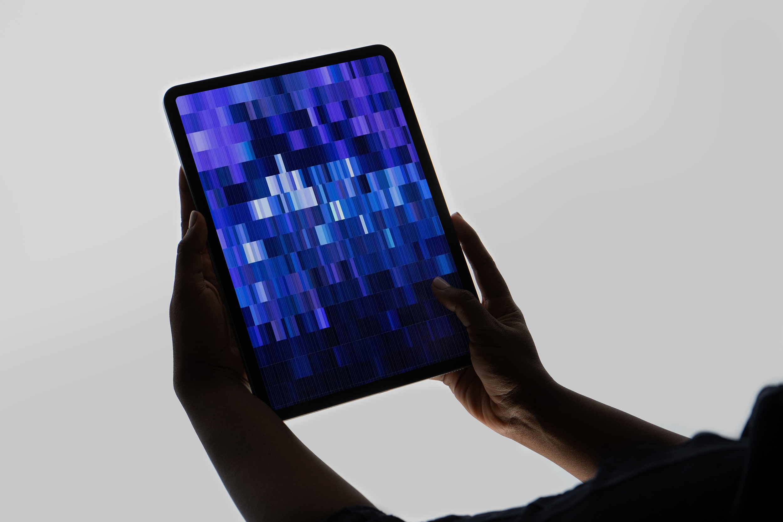 concrete grid, blue pixels animating on a handheld tablet device